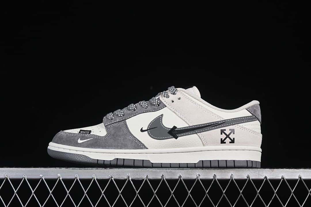 Side view of gray and white low-top sneakers with patterned laces and a layered side graphic