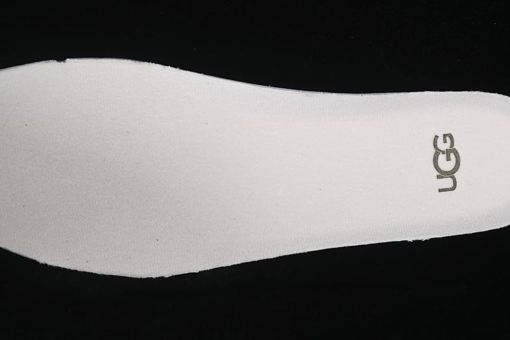 Close-up of the light-colored insole and UGG logo