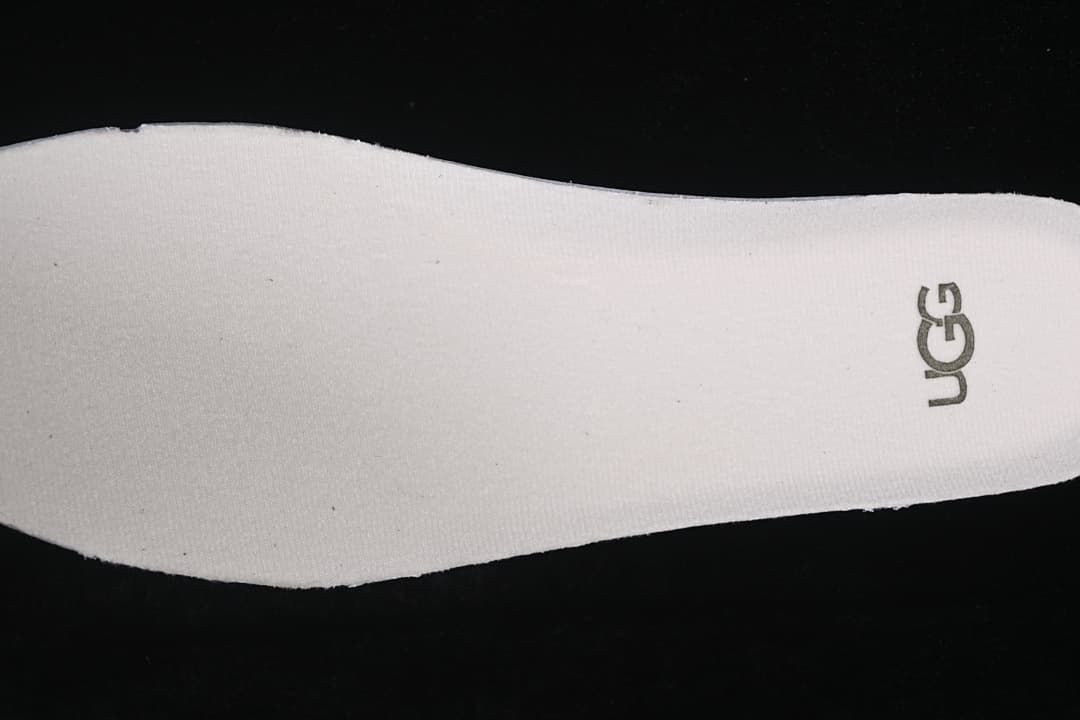 Close-up of the light-colored insole and UGG logo