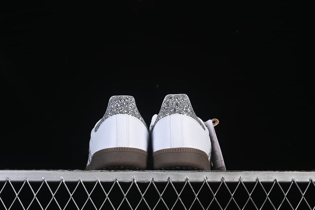 Rear view of both sneakers showing the glitter-effect heel panels.