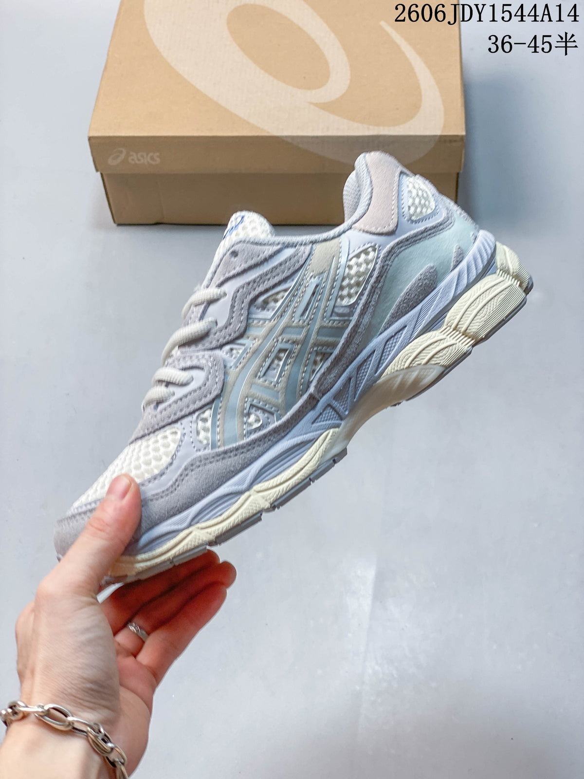 Side profile of a white and grey ASICS GEL-NYC sneaker with blue accents and layered panels.