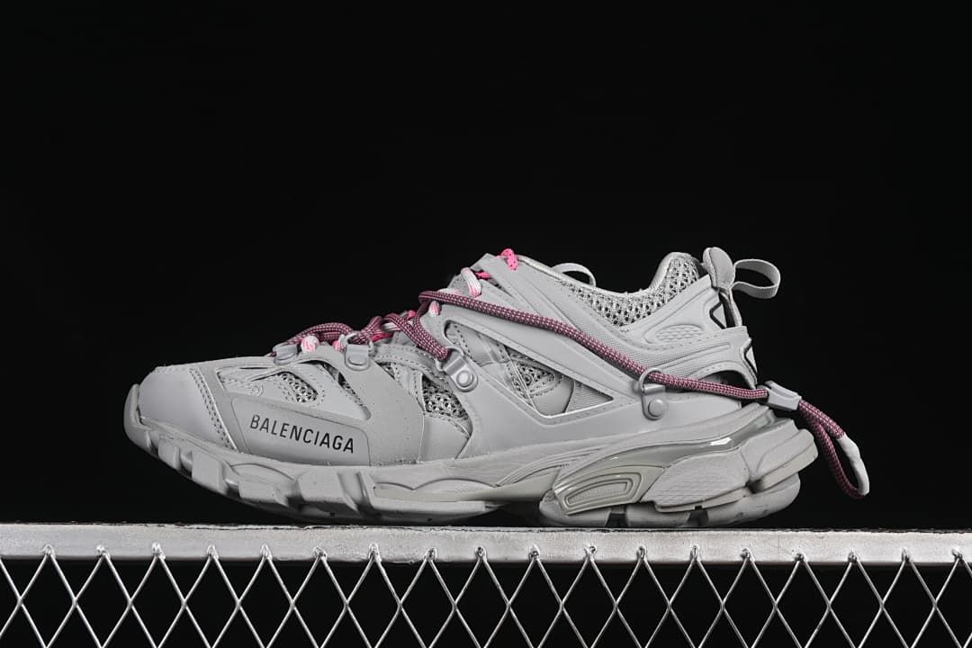 Grey Track sneaker in side profile with contrasting cord laces