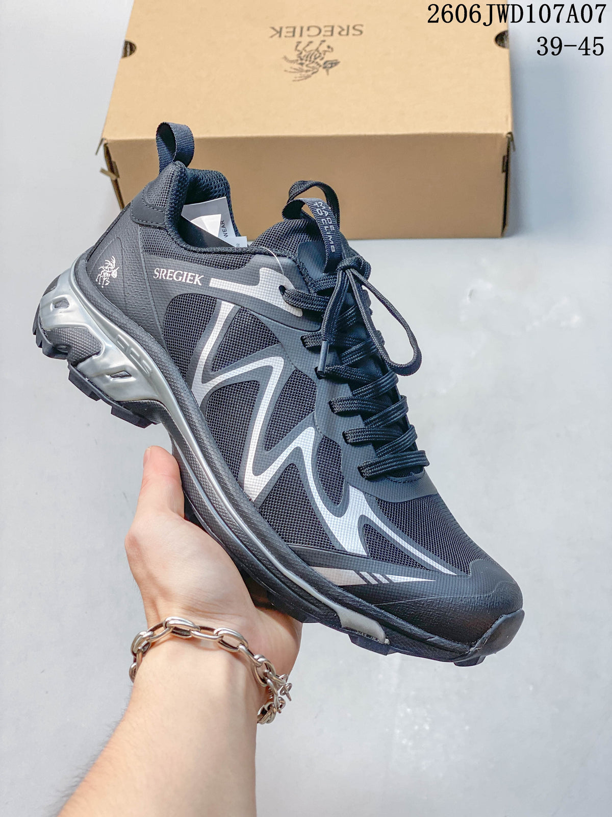 Side view of a charcoal and silver Sregiek hiking shoe with a lugged sole