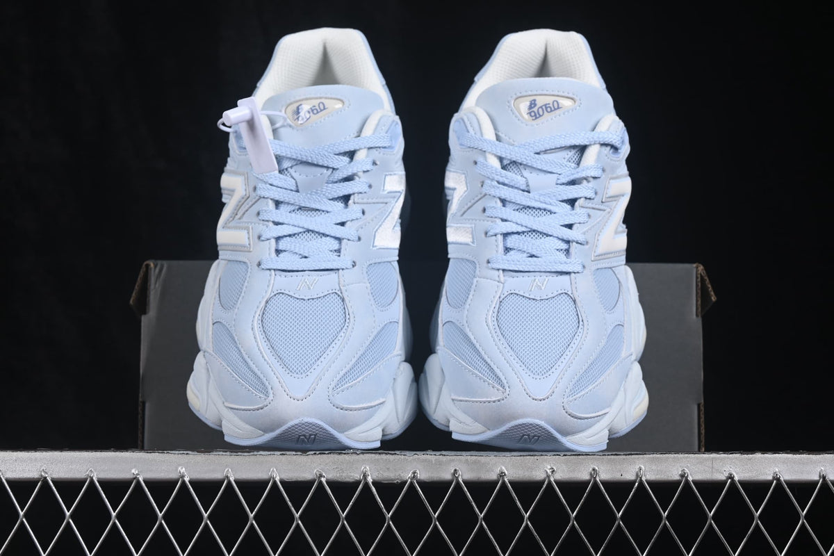 Front view of the New Balance 9060 sneakers showing mesh toe panels, laces, and padded tongues.