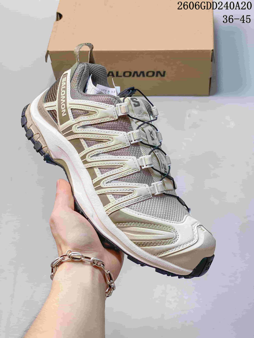 Side view of the shoe with layered overlays and dark treaded outsole.