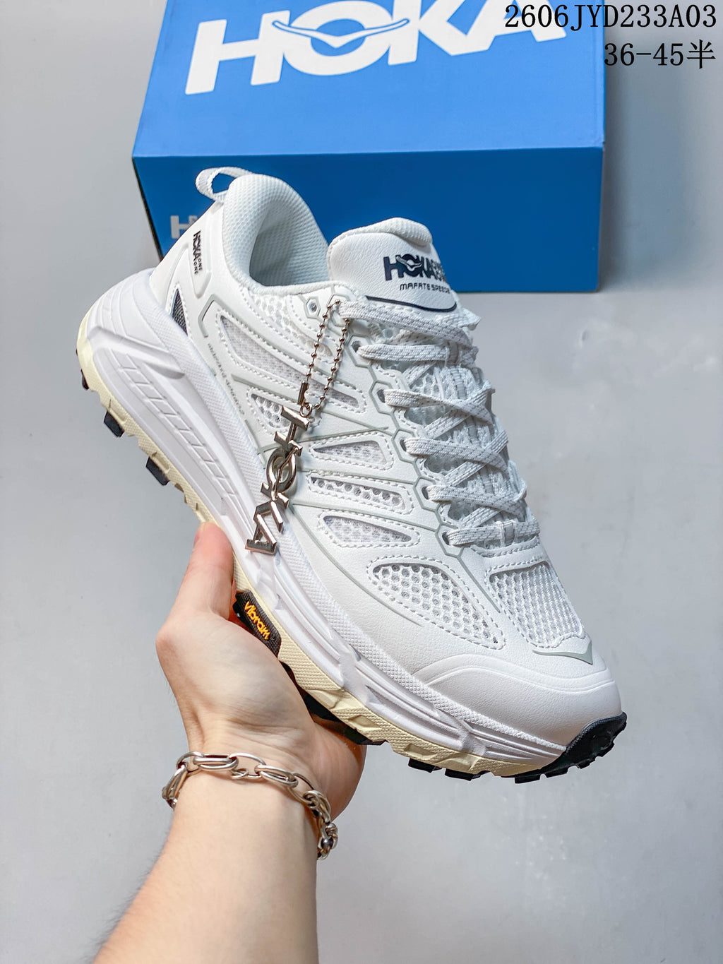 Angled side view of a white HOKA Mafate Speed trail shoe