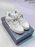 Light-colored Jordan Spizike Low sneakers displayed on a speckled box