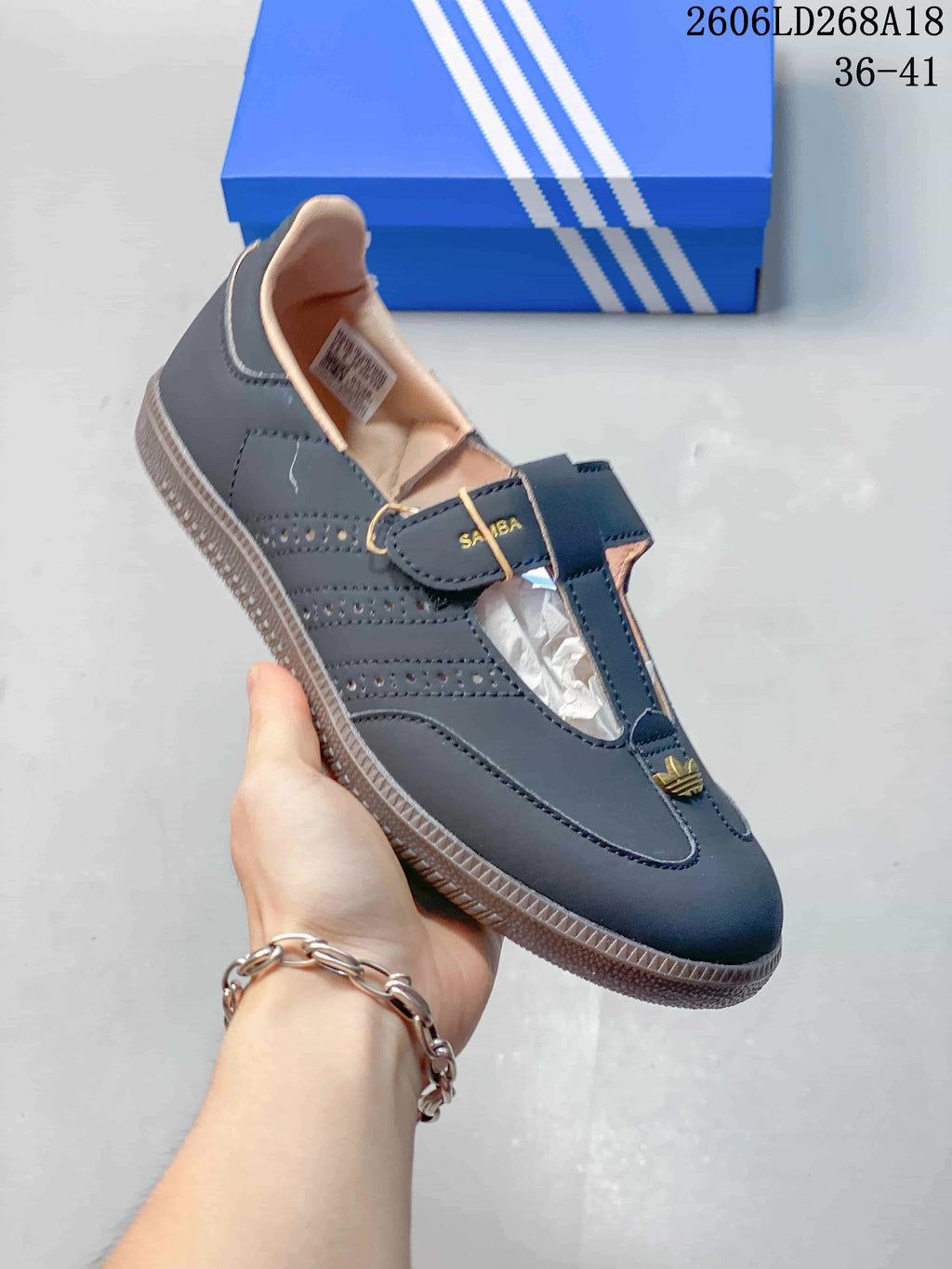 Angled view of a dark gray Samba Jane shoe with perforated side panels and gum-look sole