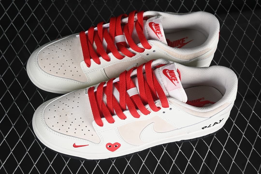 Pair of off-white low-top sneakers with red laces and decorative side graphics