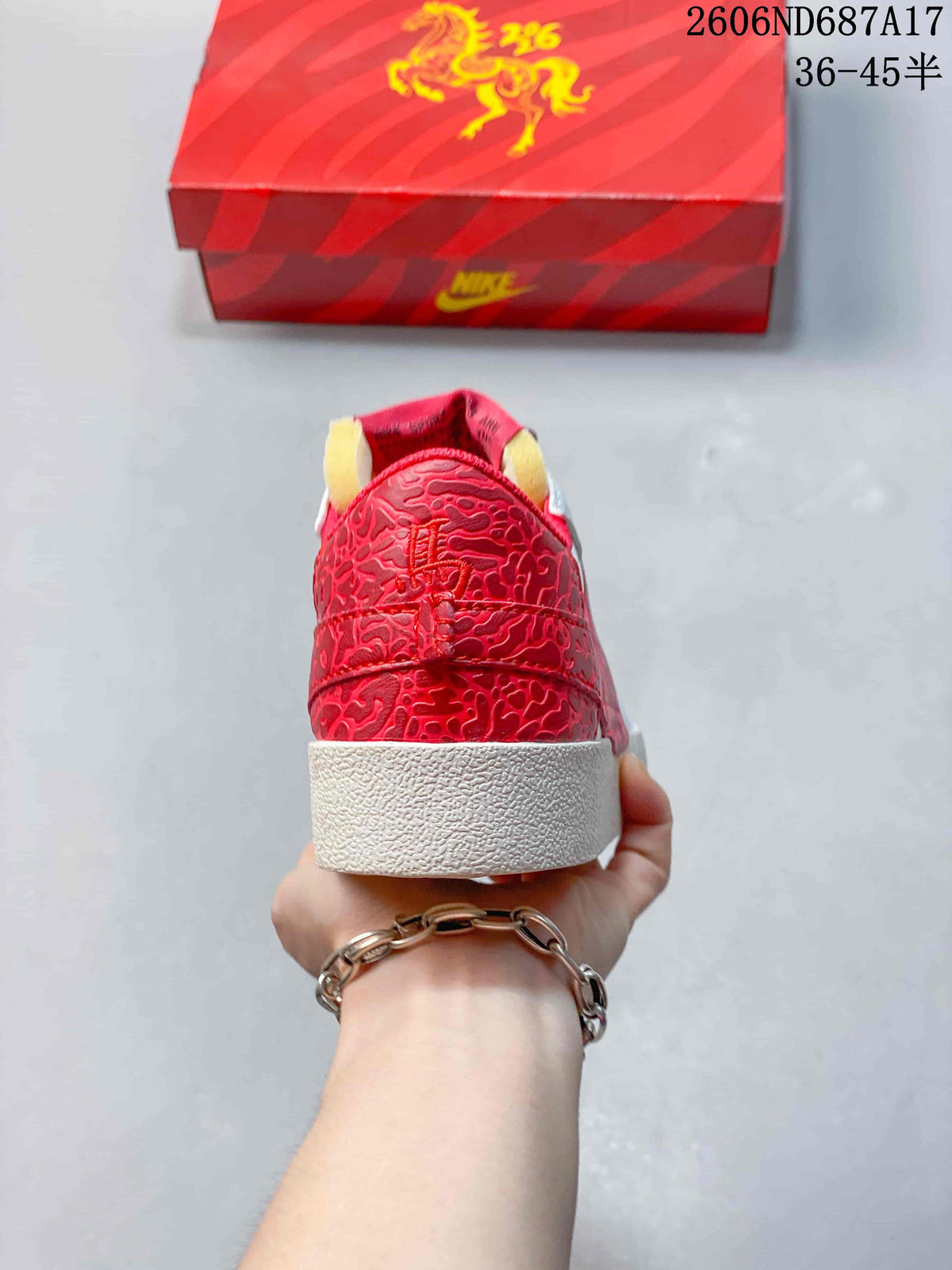 Rear view showing the red patterned heel panels and white outsole.