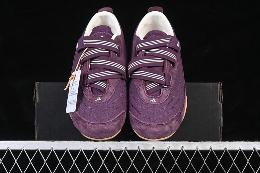Top view of the purple sneaker pair placed on a shoe box