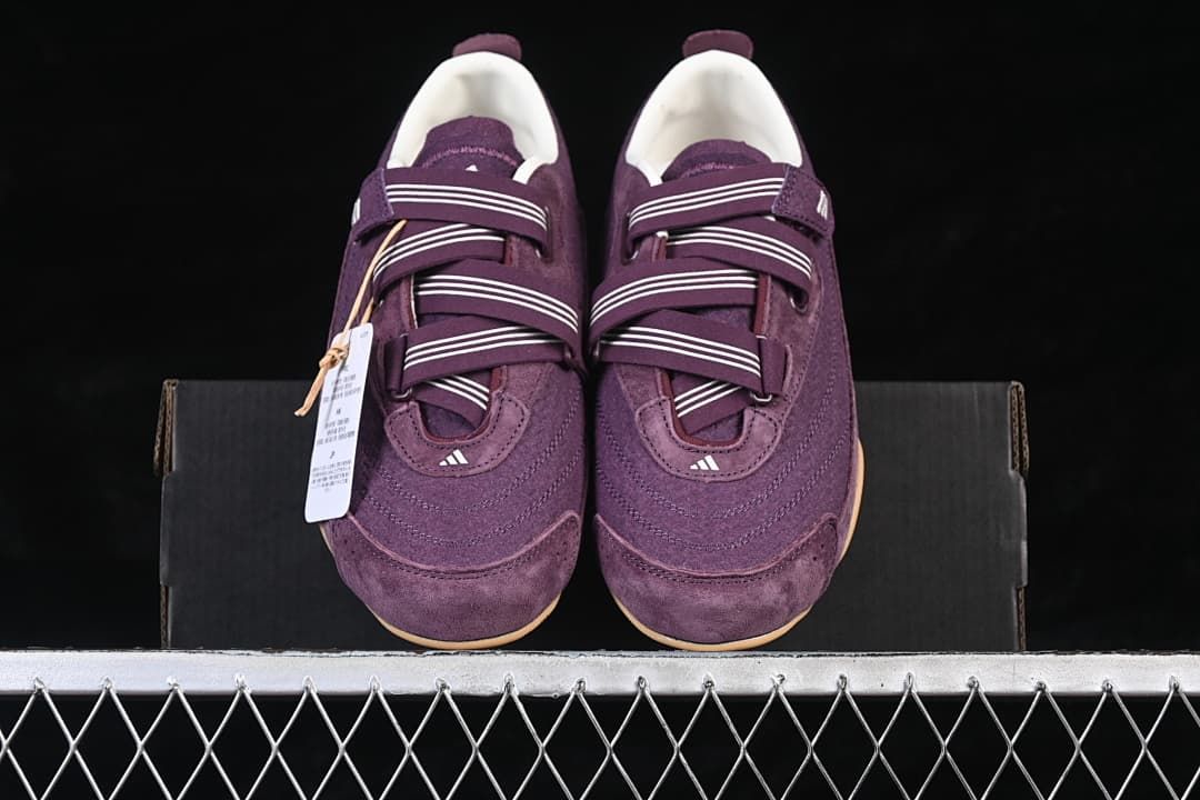 Top view of the purple sneaker pair placed on a shoe box