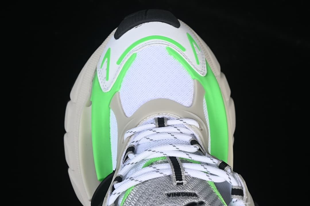 Top-down view highlighting the laces and bright green trim around the toe.