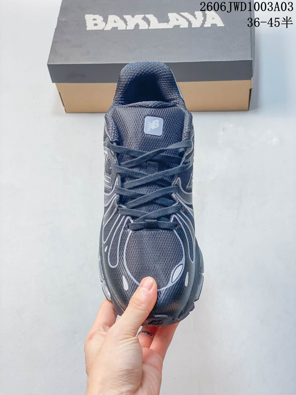 Front view of the sneaker showing its laces and layered upper detailing.