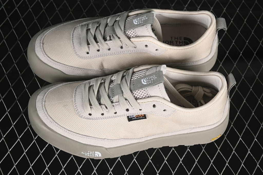 Pair of neutral low-top sneakers shown from above and the side