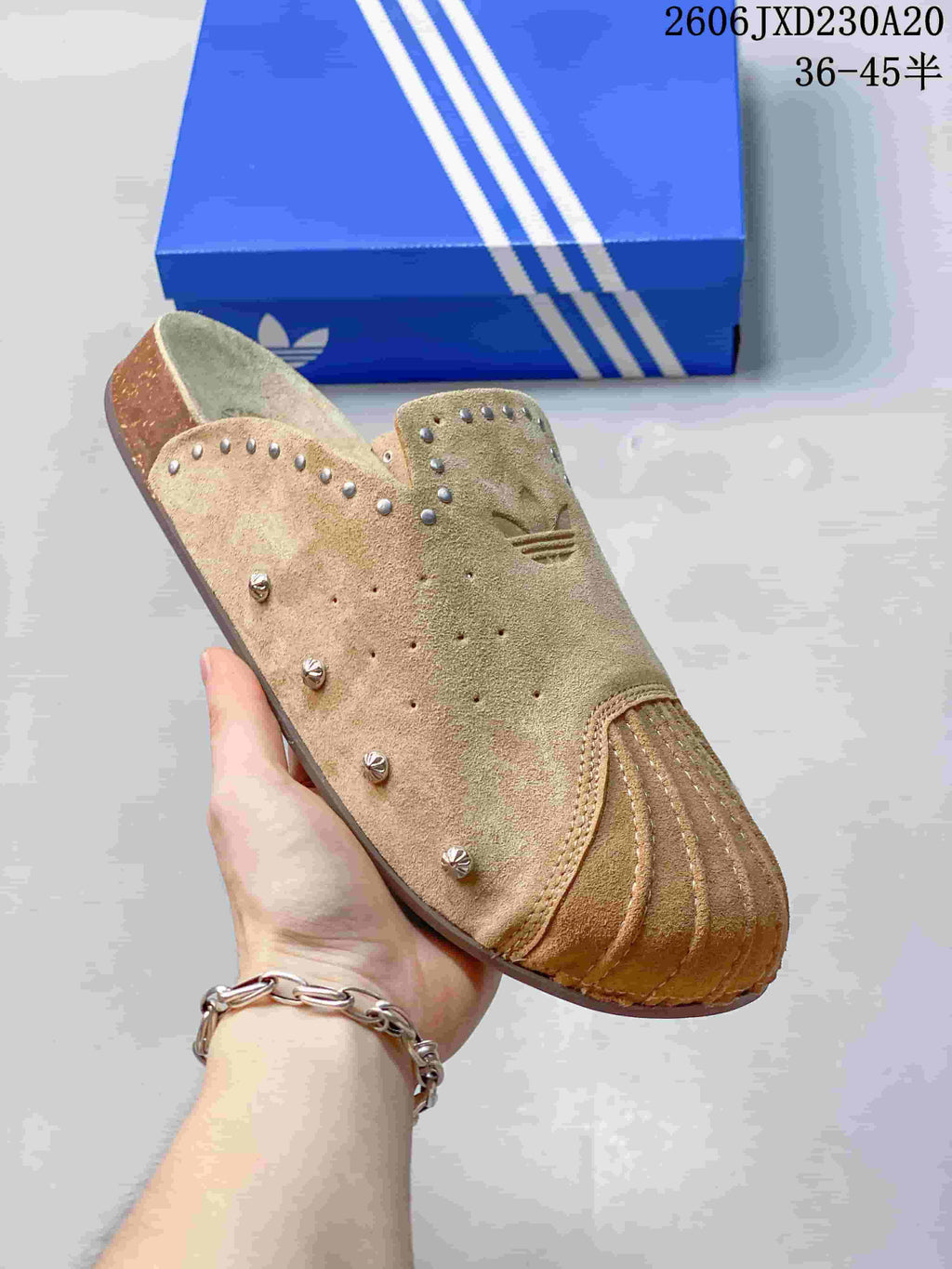 Angled view of a tan adidas Adimule mule slide with decorative studs