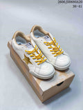 White Golden Goose Super-Star low-top sneakers with gold stars and yellow laces