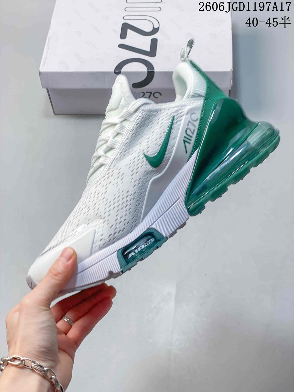Side profile of the white and green Nike Air Max Pulse sneaker.
