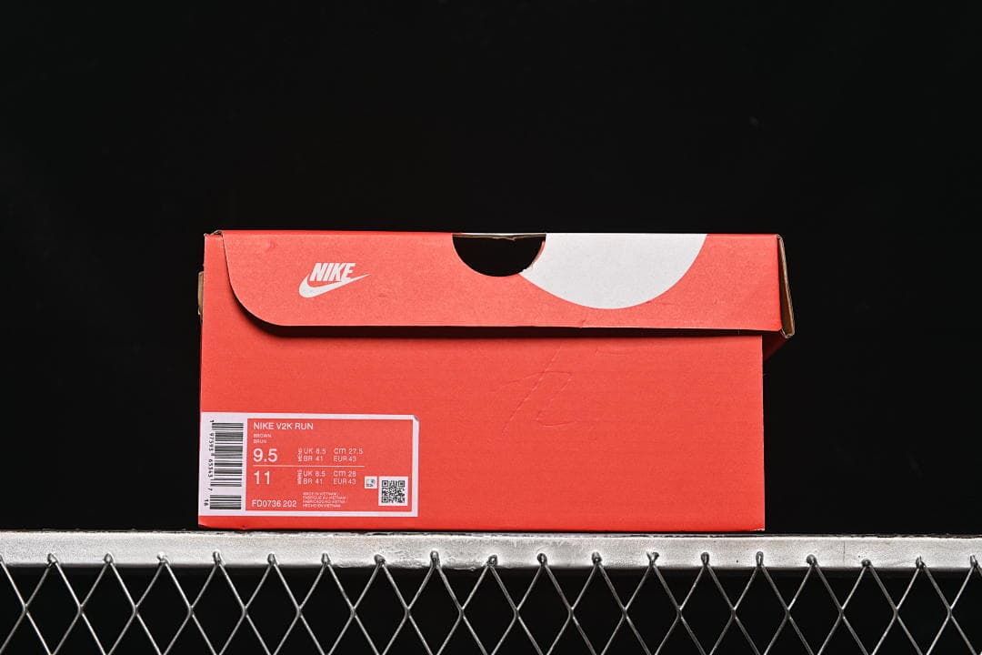 Nike shoe box with a visible V2K Run and FD0736-202 label