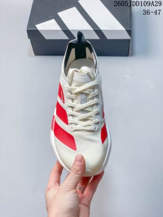 Top view of the white and red Adidas shoe showing the laces, toe box, tongue, and side stripes.