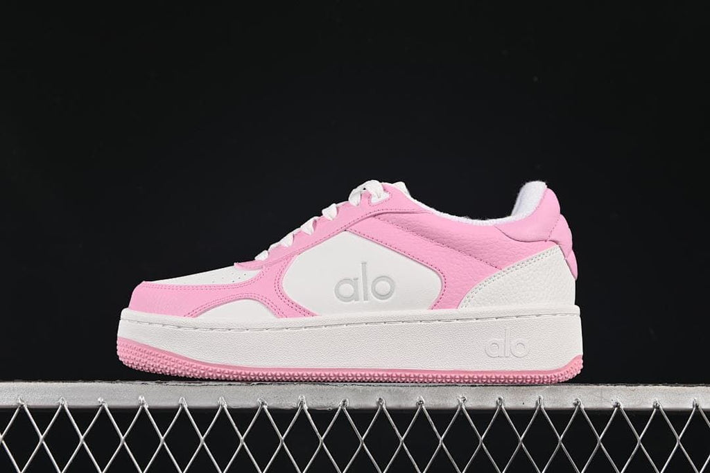 Side view of pink and white Alo Recovery Mode low-top sneakers