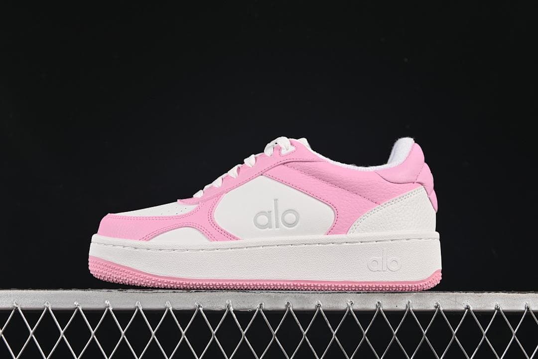 Side view of pink and white Alo Recovery Mode low-top sneakers