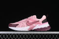 Side view of pink Nike V2K Run sneakers with burgundy and white accents
