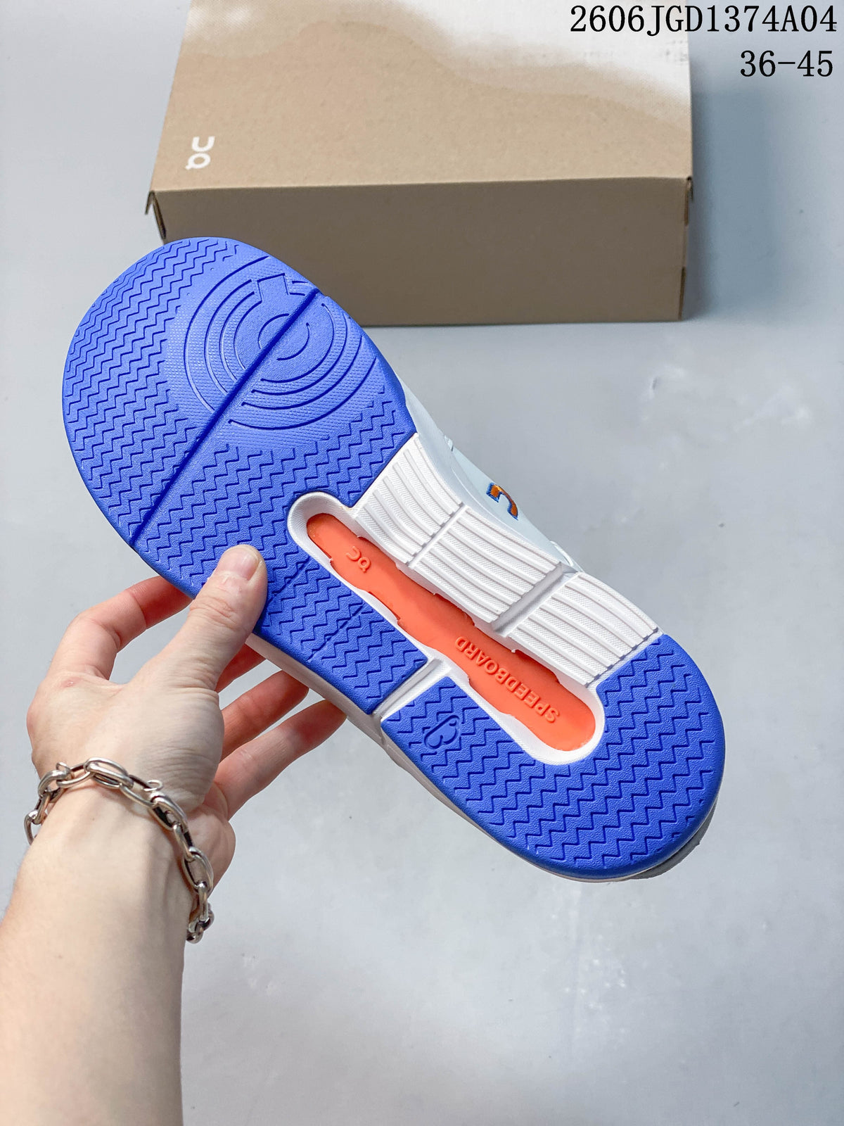 Outsole of the white sneaker showing blue tread and an orange center section