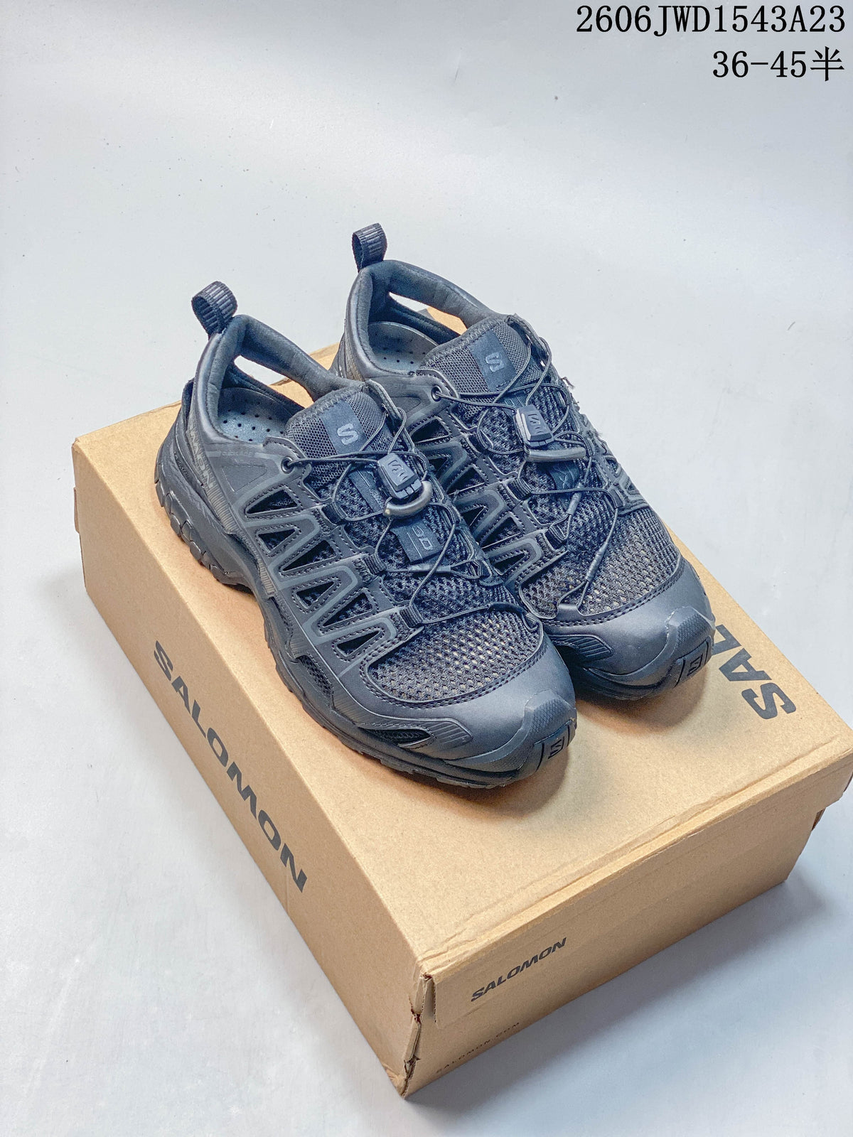 Dark gray Salomon XA Pro 3D Amphib sneakers shown from above beside a shoe box