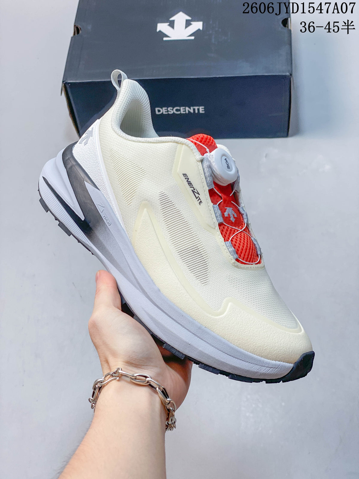Angled side view of a cream DESCENTE shoe with red closure details and a layered sole.