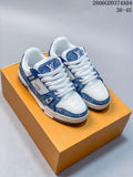 Pair of blue-and-white Louis Vuitton Trainer low-top sneakers shown from above on an orange box