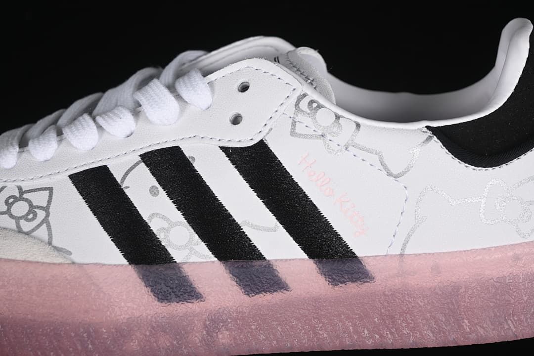 Side close-up showing black stripes, Hello Kitty graphics, white laces, and pink sole.