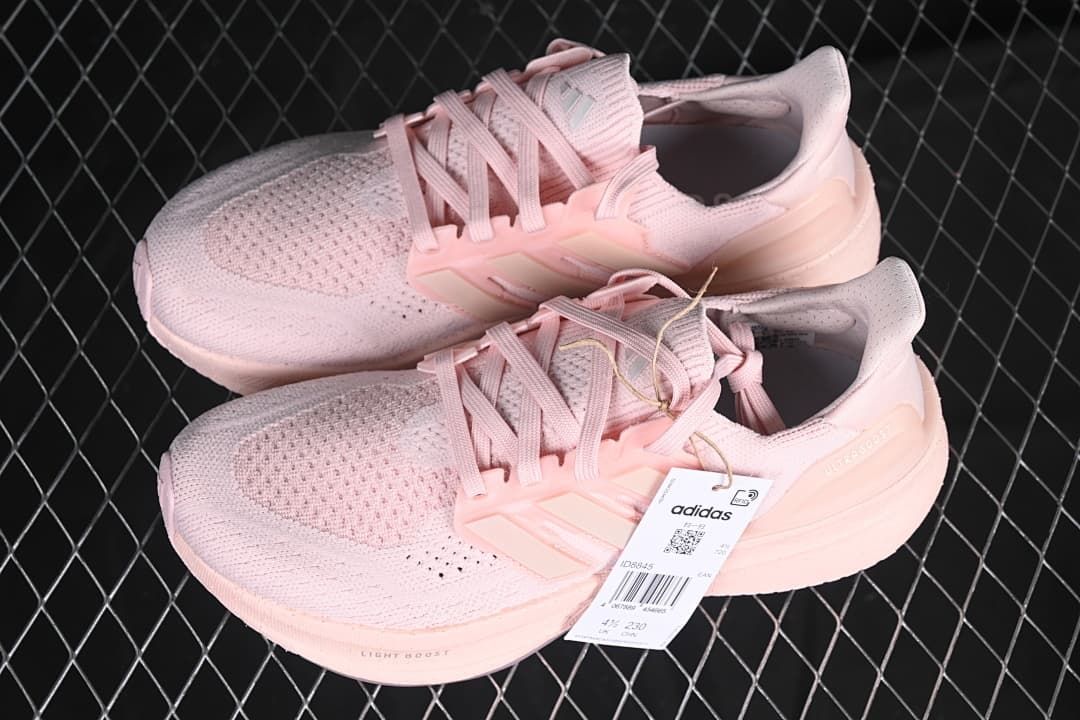 Pair of pink Ultraboost 5 W shoes shown from above and the side