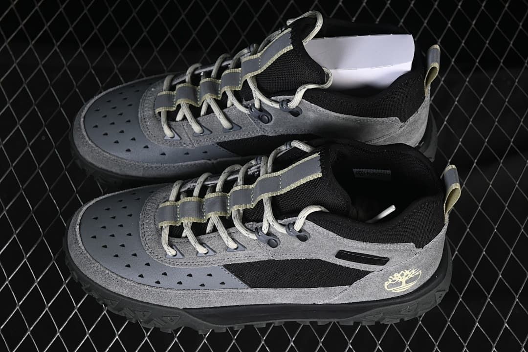 Pair of grey and black mid-cut lace-up sneakers shown from above and the side.