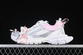 Side view of white Balenciaga 3XL-style sneakers with silver-toned details, pink trim, and ribbon bows.