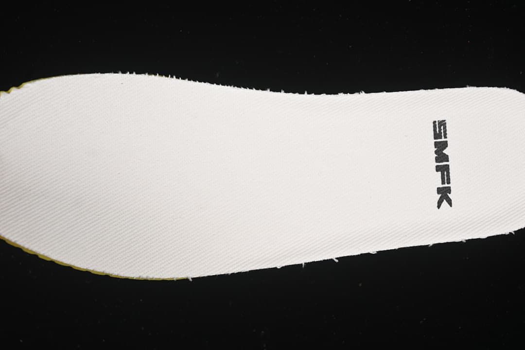 Close-up of a white insole with SMFK branding.