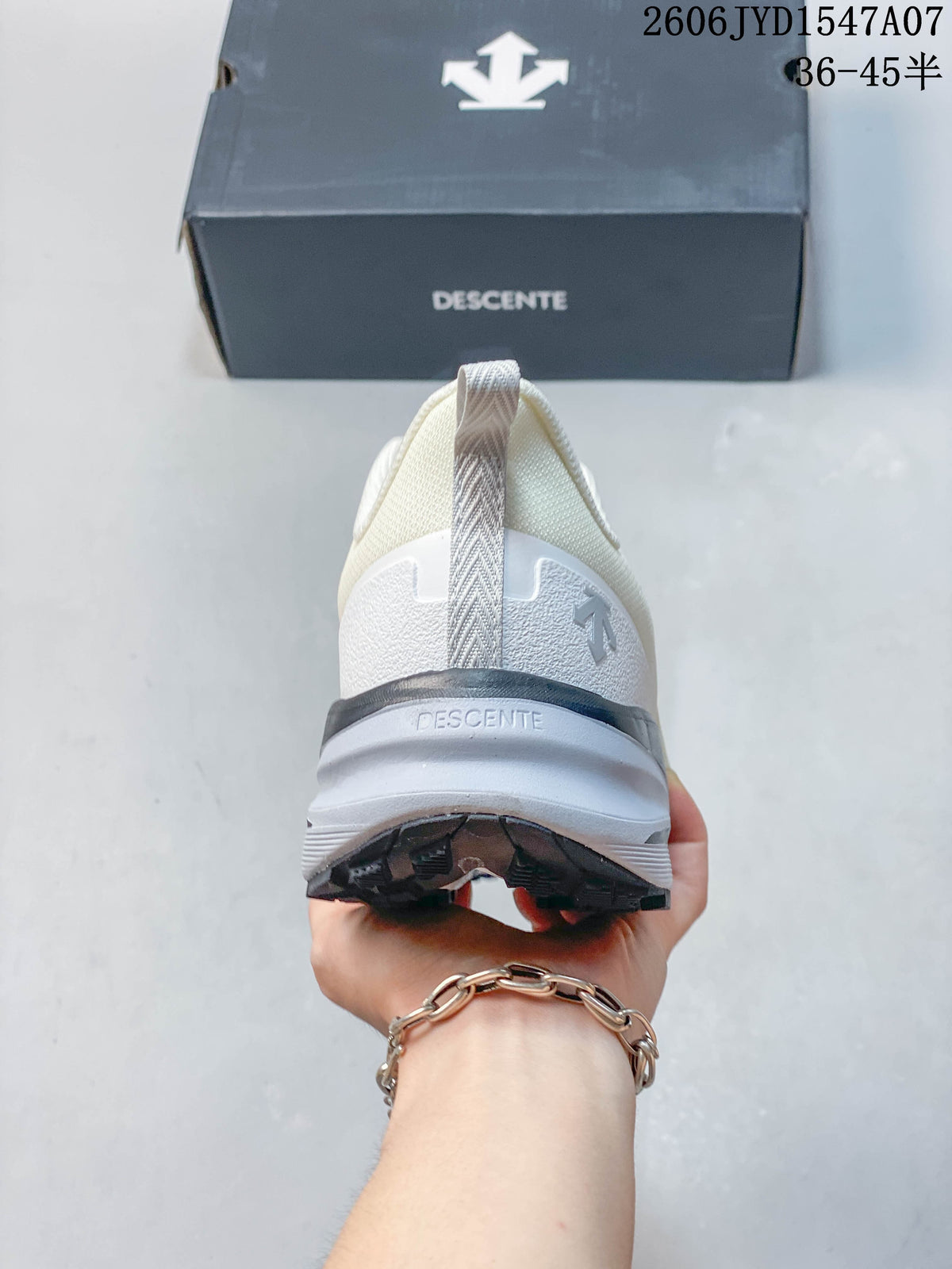 Rear view of a cream DESCENTE shoe with heel loop, layered midsole, and dark outsole.