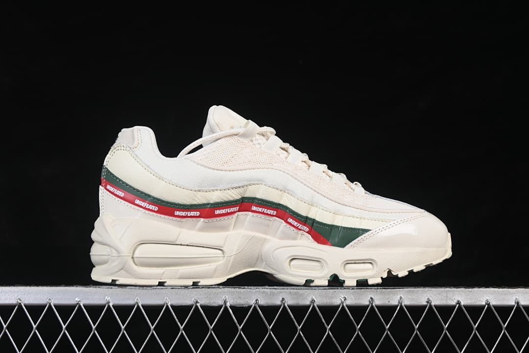 Side profile of the off-white sneaker with layered panels and green and red accents.
