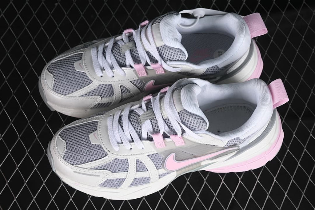 Pair of white, grey, and pink sneakers viewed from above.