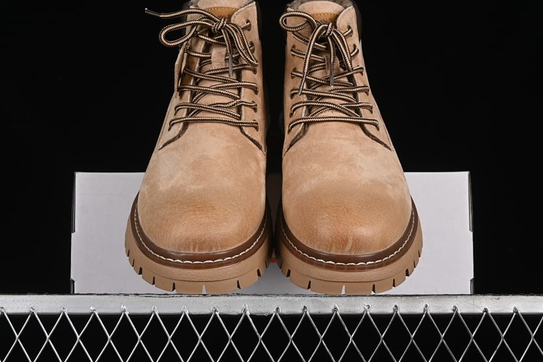 Front view of the pair of beige lace-up boots