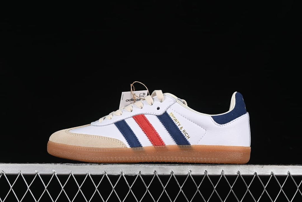 Side view of the adidas Samba OG Sporty & Rich in white, navy, red, and sand tones