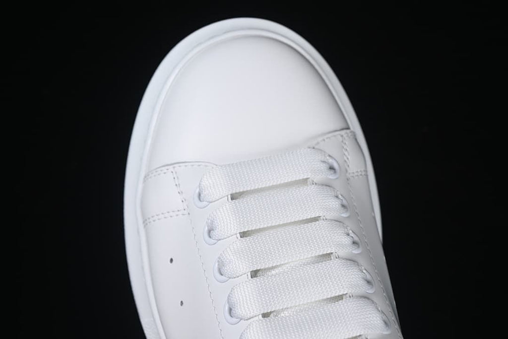 Top-front detail of the white toe and lace-up area.