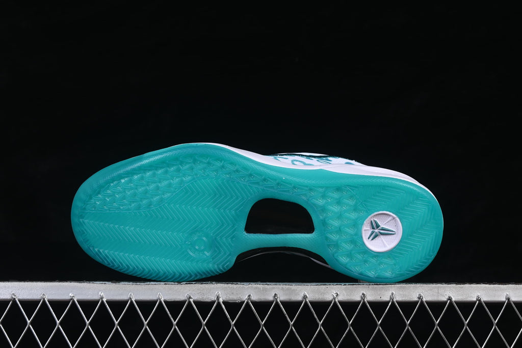 Underside view of the teal outsole and traction pattern