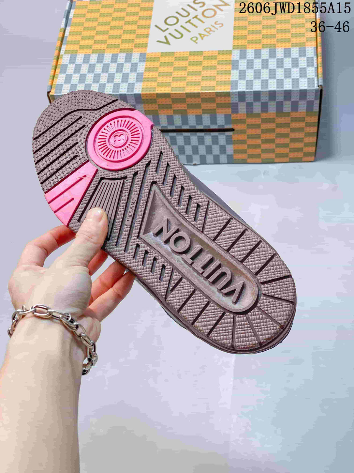 Close-up of the sneaker outsole showing textured tread and a pink accent.