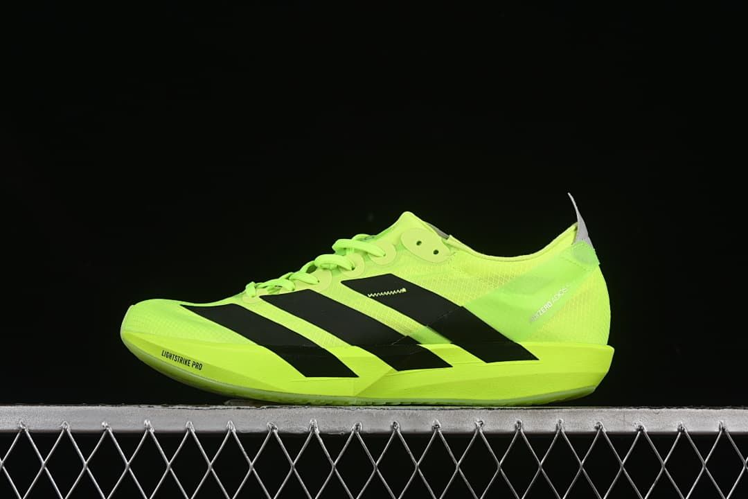 Side view of a neon yellow Adidas Adizero running shoe with black stripes