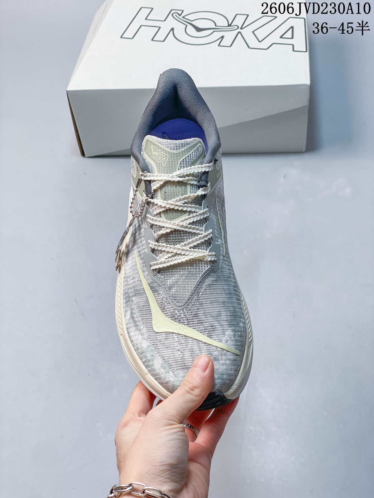 Front view of a grey HOKA Rocket X 3 shoe with cream-colored laces.