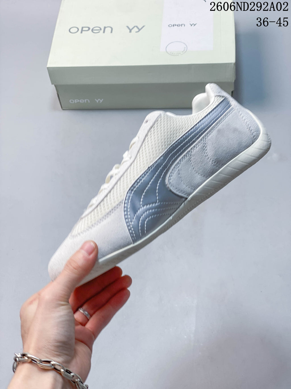 Side view of an off-white Puma Speedcat sneaker with silver-gray Formstrip.