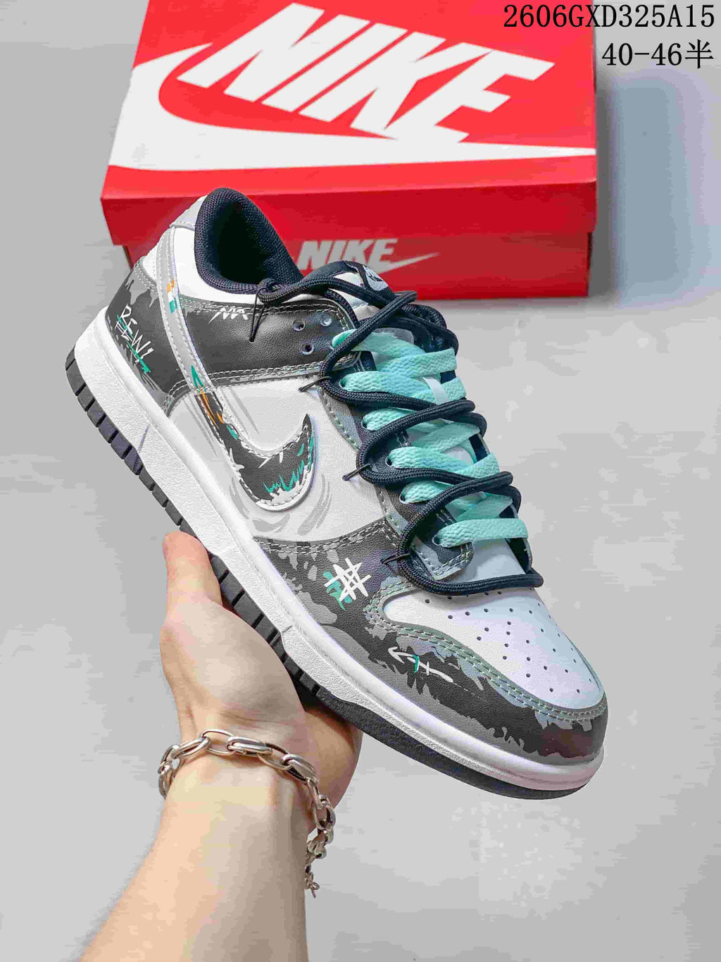 Side view highlighting the gray graphic overlays, white panels, and aqua laces