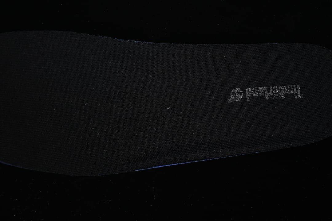 Dark insole shown separately against a dark background.