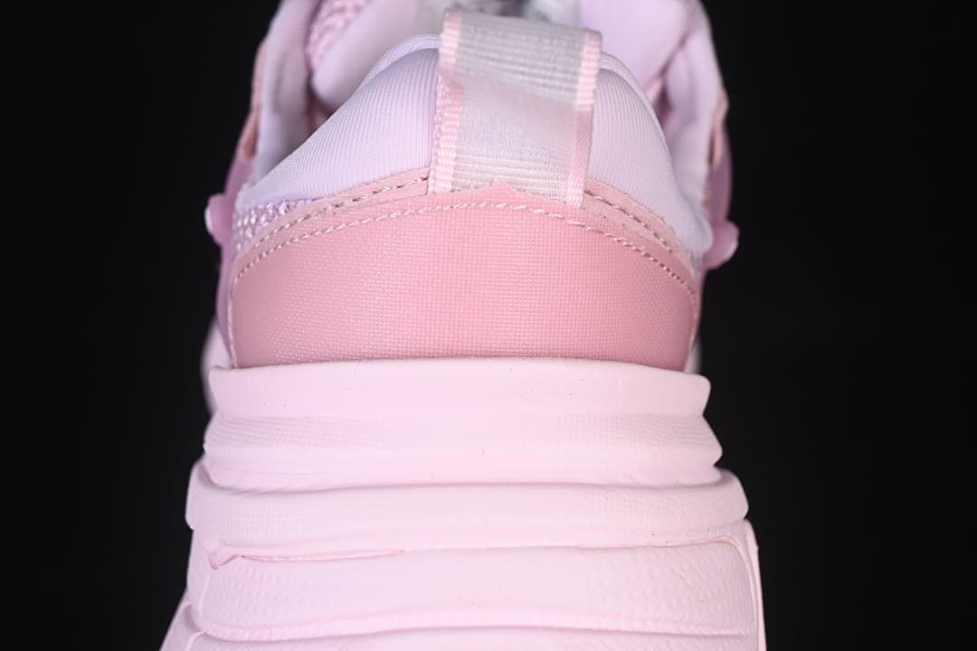 Rear close-up of the pink sneaker showing the heel panel, pull tab and layered sole.